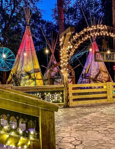Illuminated tipis and string lights at Deadwood after dark near Williamston, NC