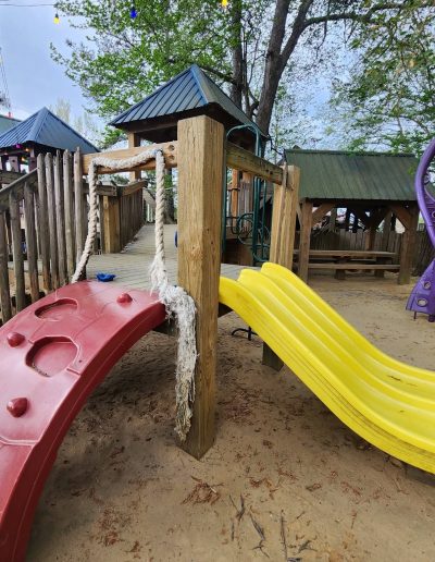 Red climbing arch and yellow slide in the Deadwood playground near Williamston, NC