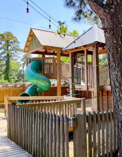 Wooden playground towers with a green spiral slide at Deadwood near Williamston, NC