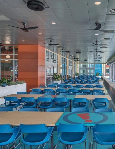 Covered dining patio with blue chairs at Frankie's of Charlotte in Huntersville, NC.
