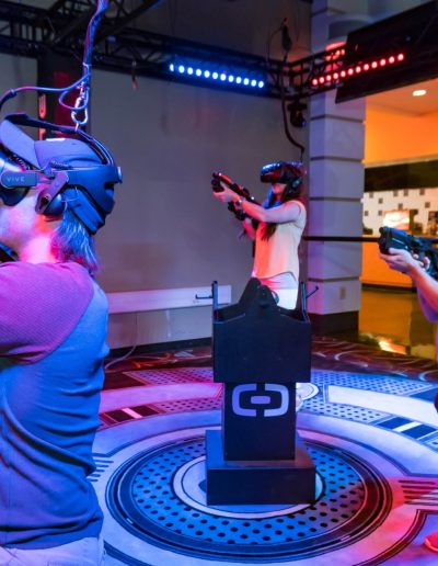 Players wearing headsets in a virtual reality arena at Frankie's of Charlotte in Huntersville, NC.