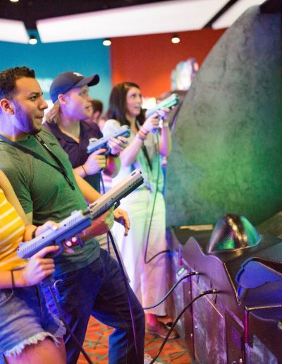 Group playing an arcade shooting game at Frankie's of Charlotte in Huntersville, near Mount Holly.