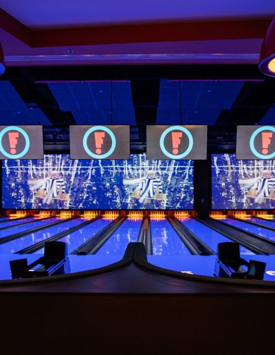 Bowling lanes beneath large video screens at Frankie's of Charlotte in Huntersville, NC.