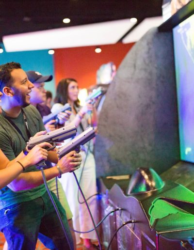 Arcade players aiming controllers at a large screen at Frankie's of Charlotte in Huntersville, NC.