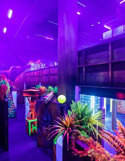 Purple-lit laser tag arena with themed scenery at Frankie's of Charlotte in Huntersville, near Kannapolis.