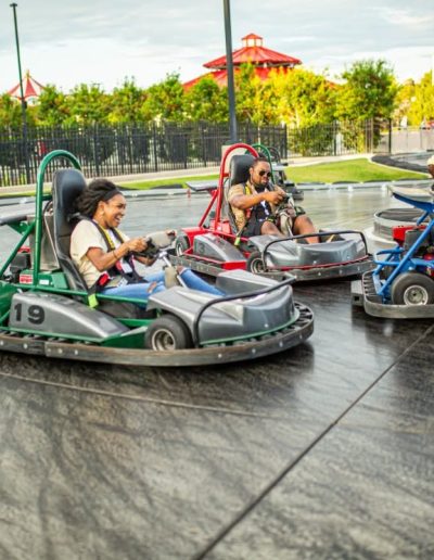 Three go-karts rounding a track bend at Frankie's of Charlotte in Huntersville, NC.