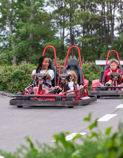 Riders in red double-seat go-karts at Frankie's of Charlotte in Huntersville, NC.