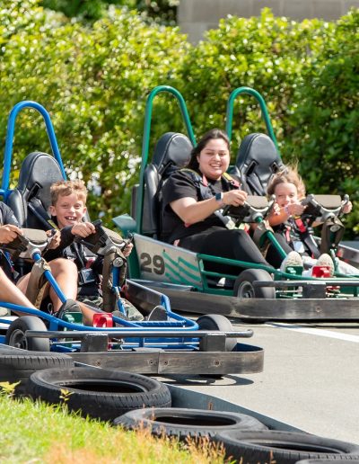 Adults and children riding double-seat go-karts at Frankie's of Charlotte in Huntersville, NC.