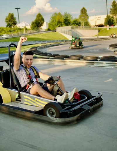 Driver waving from a yellow go-kart at Frankie's of Charlotte in Huntersville, near Mount Holly.