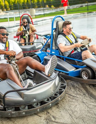 Go-kart drivers racing side by side at Frankie's of Charlotte in Huntersville, NC.