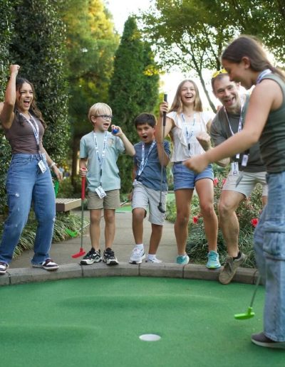 Group cheering as a player putts at Frankie's of Charlotte in Huntersville, near Davidson.