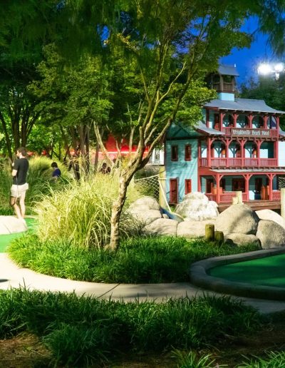 Illuminated mini-golf green beside a riverboat feature at Frankie's of Charlotte in Huntersville, near Cornelius.